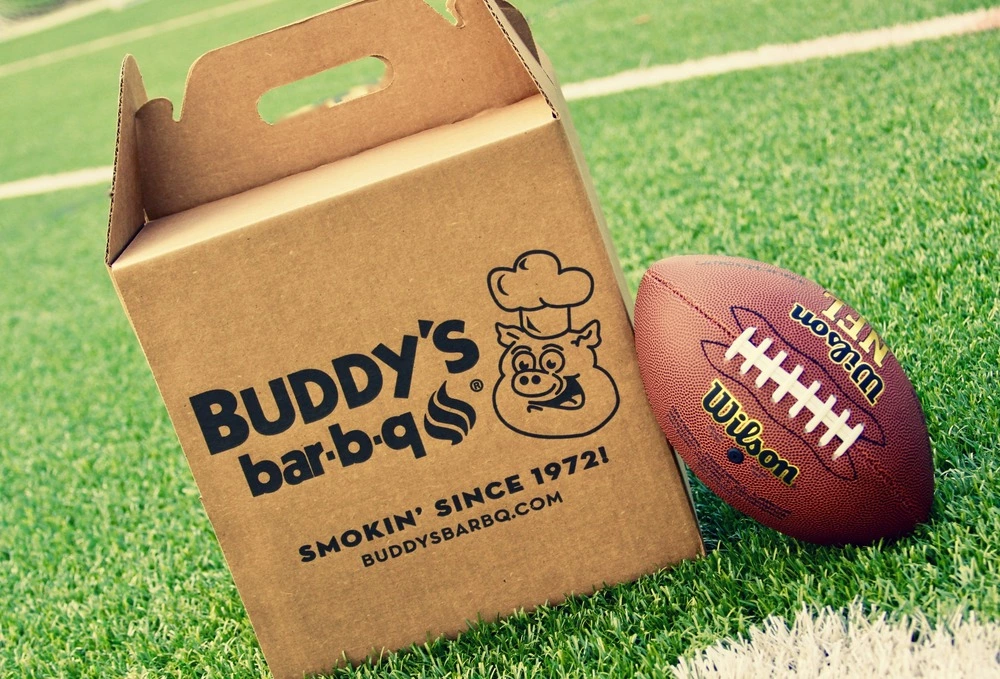 Buddy's bar-b-q catering box on football field next to football