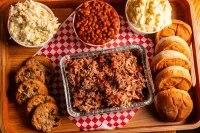 Buddy's bulk barbecue pork with buns, sides, and cookies