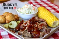 Buddy's BBQ pork dinner with slaw, corn on the cob, hushpuppies
